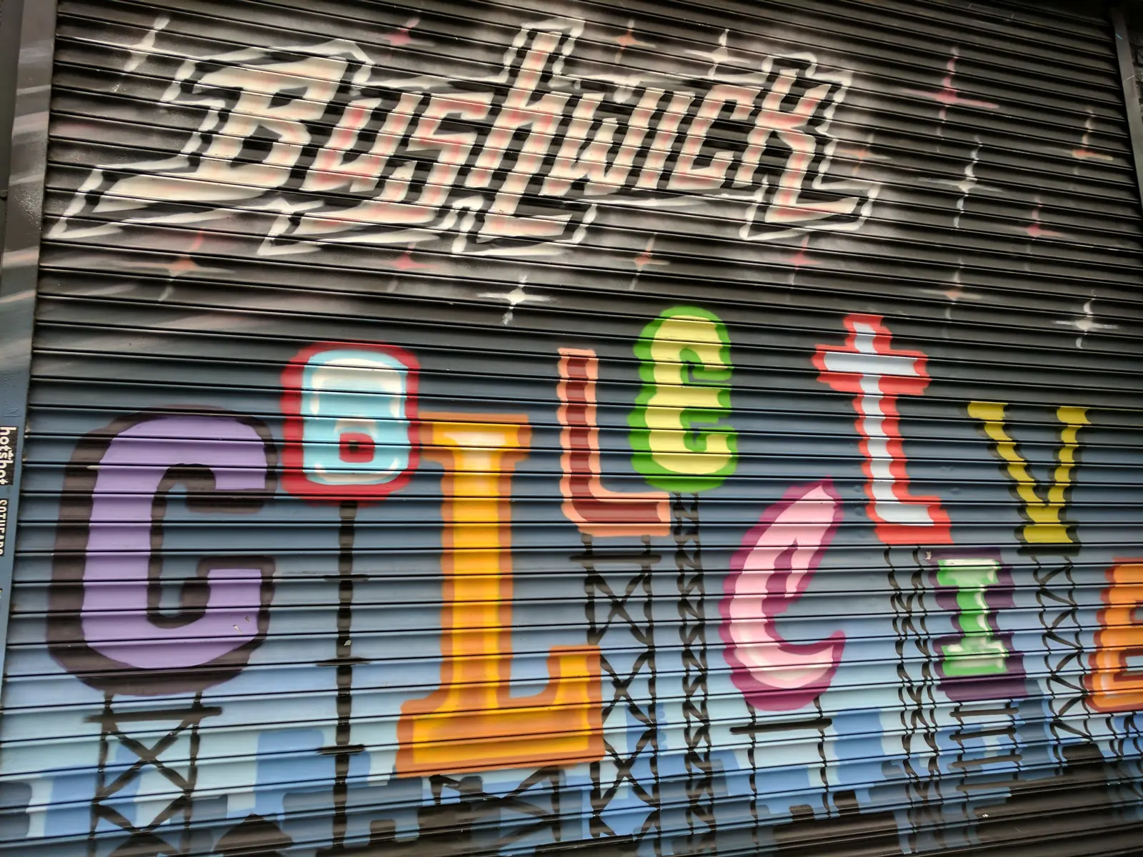 Hand-painted Bushwick Collective lettering on a roll-down shutter in Brooklyn