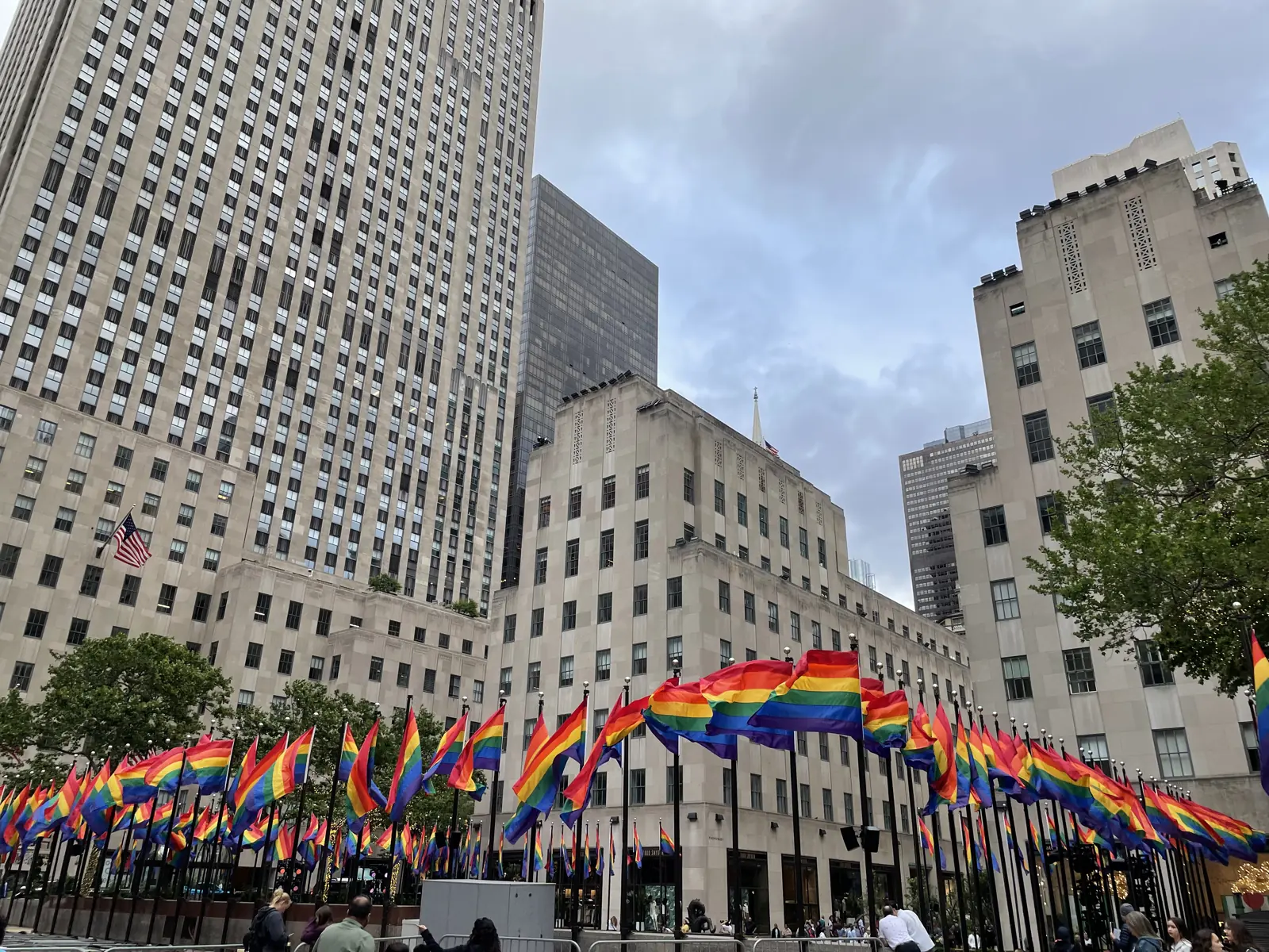 Rows of rainbow Pride flags flying at Rockefeller Center in June