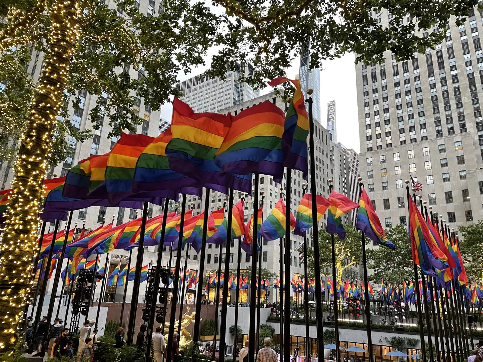 Rainbow flags around the rink at Rockefeller Plaza during Pride month
