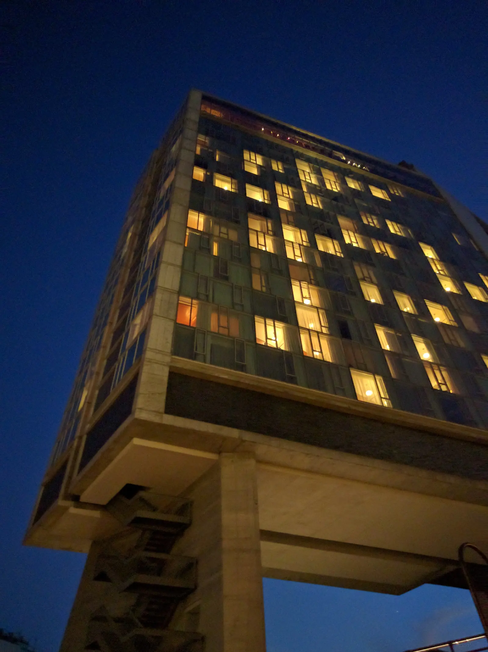 A hotel straddling the High Line in the Meatpacking District, lit up at night