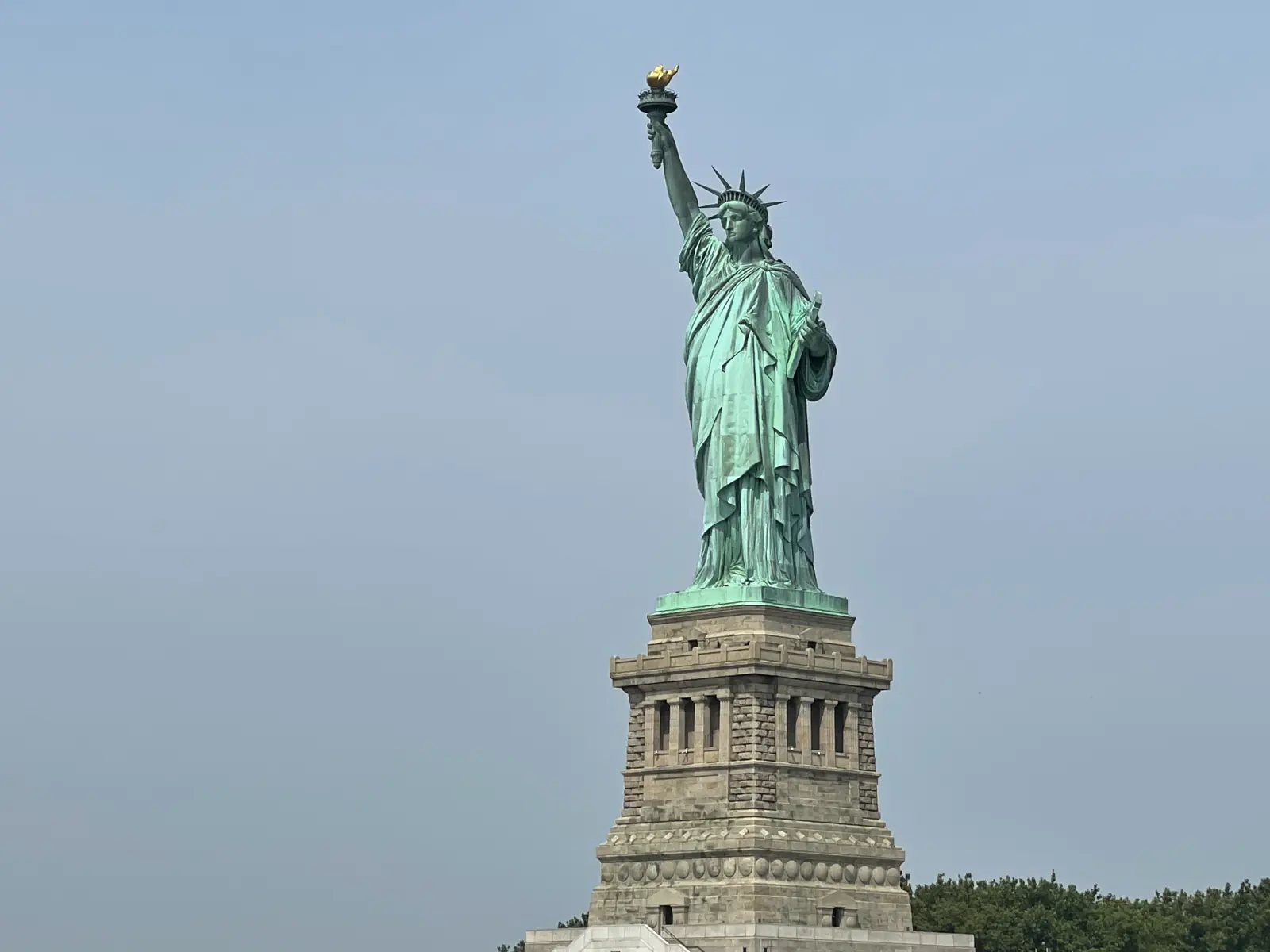 The Statue of Liberty seen from the water on a hazy day
